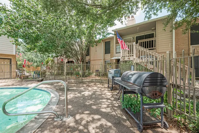 a view of a chair and table in backyard of the house