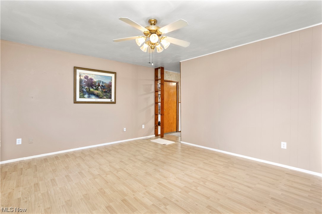 387 Fairfax Road Vermilion, OH 44089 - Photo 6 of 35 Wood floored empty room with ceiling fan