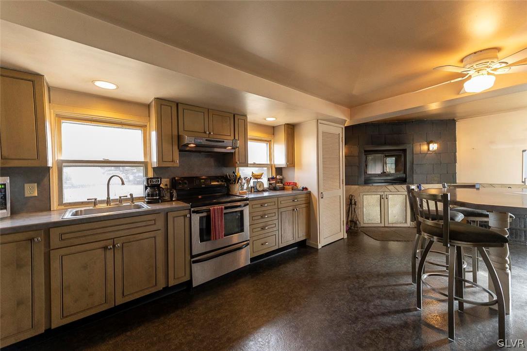 202 Fern Road Riegelsville, PA 18077 - Photo 6 of 18 a kitchen with stainless steel appliances kitchen island granite countertop a stove a sink and a microwave