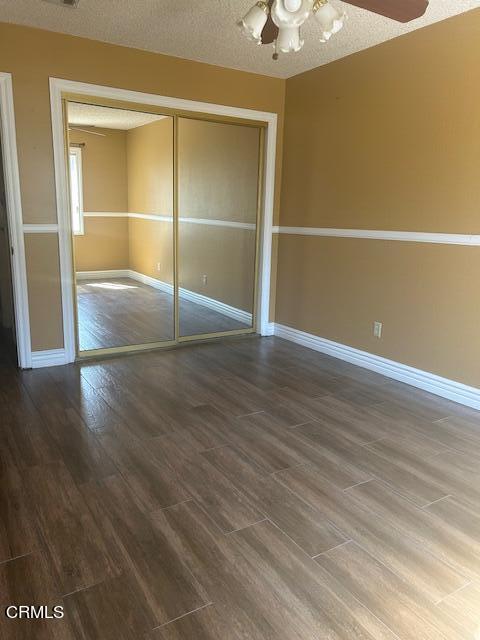 323 Sycamore Street Santa Paula, CA 93060 - Photo 15 of 20 an empty room with wooden floor and a ceiling fan