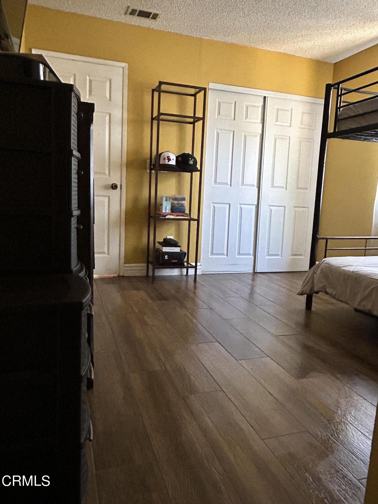 323 Sycamore Street Santa Paula, CA 93060 - Photo 19 of 20 a view of hallway with wooden floor and furniture