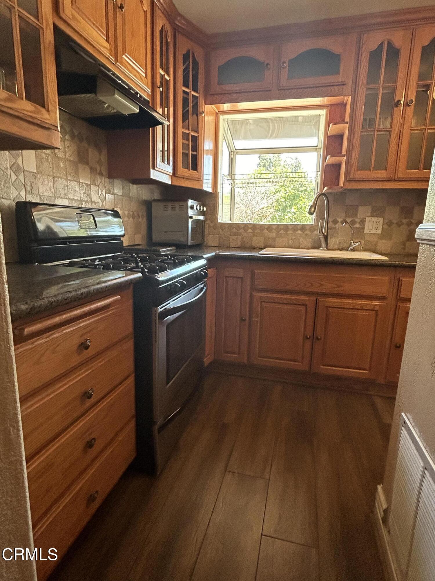 323 Sycamore Street Santa Paula, CA 93060 - Photo 5 of 20 a kitchen with stainless steel appliances granite countertop a stove and a sink