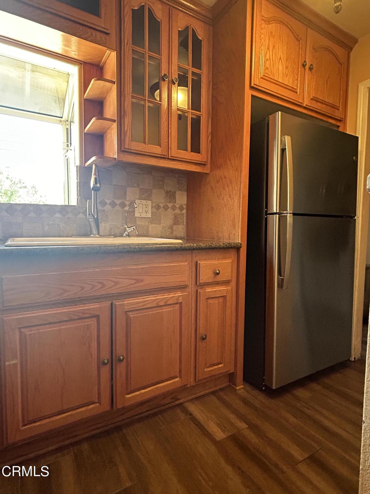 323 Sycamore Street Santa Paula, CA 93060 - Photo 6 of 20 a kitchen with stainless steel appliances granite countertop a refrigerator and a sink
