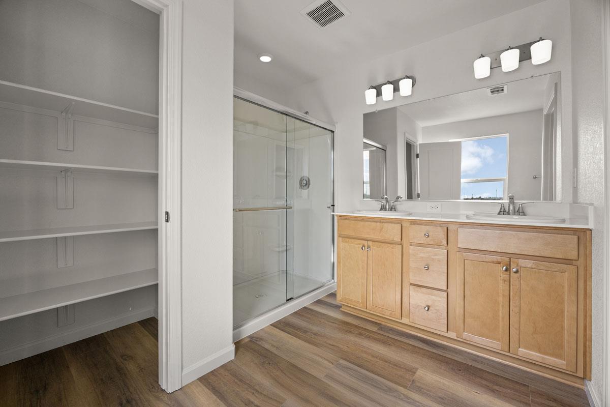 2318 East Loomis Road Stockton, CA 95205 - Photo 11 of 20 a bathroom with a double vanity sink and a mirror