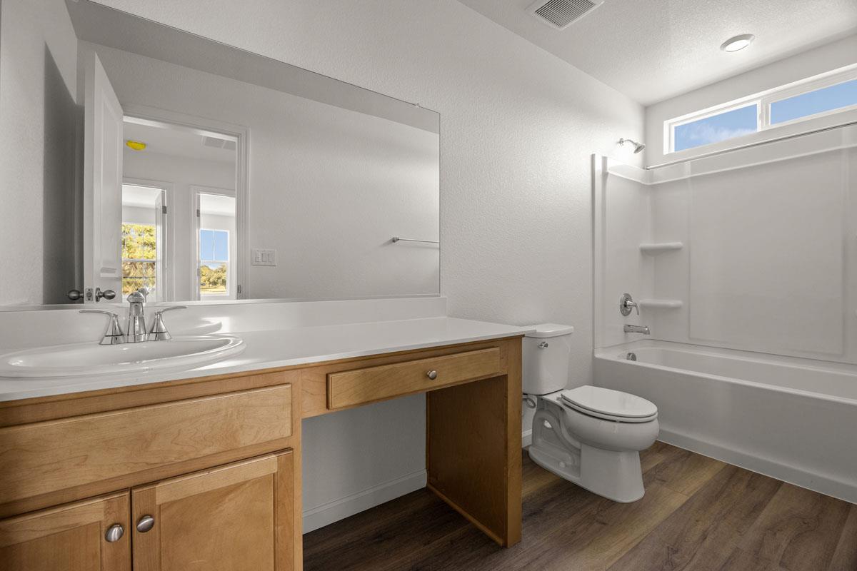 2318 East Loomis Road Stockton, CA 95205 - Photo 12 of 20 a bathroom with a sink a toilet a mirror and shower