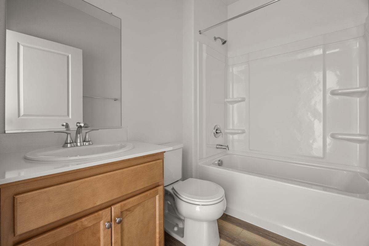 2318 East Loomis Road Stockton, CA 95205 - Photo 4 of 20 a bathroom with a granite countertop sink toilet and shower