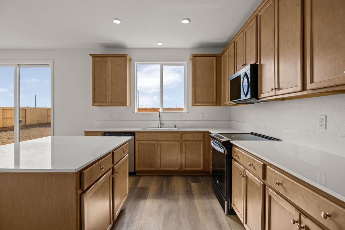 2318 East Loomis Road Stockton, CA 95205 - Photo 8 of 20 a kitchen with stainless steel appliances granite countertop a sink stove and cabinets