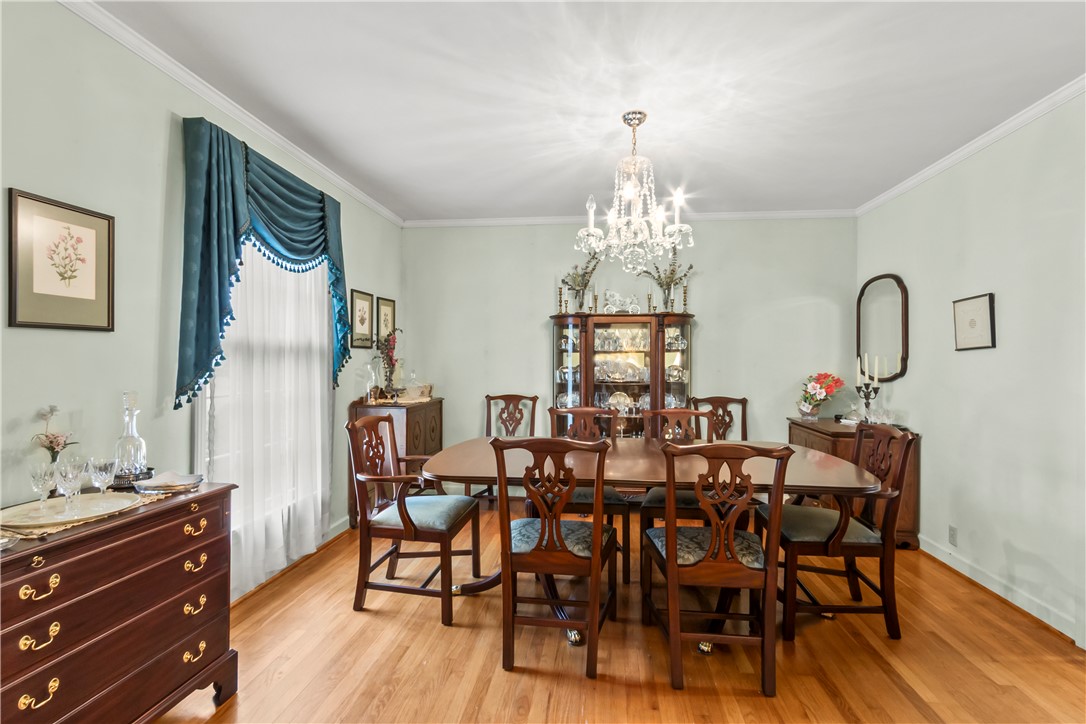 118 Blair Road Belton, SC 29627 - Photo 9 of 49 Hardwood floors and classic crown molding elevate this elegant dining space.