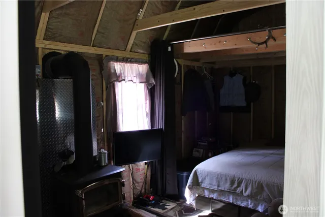 a bedroom with a bed and a mirror