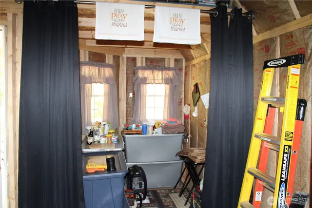 a view of a dining room with a table and chairs
