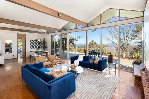 a living room with furniture a couch and wooden floor