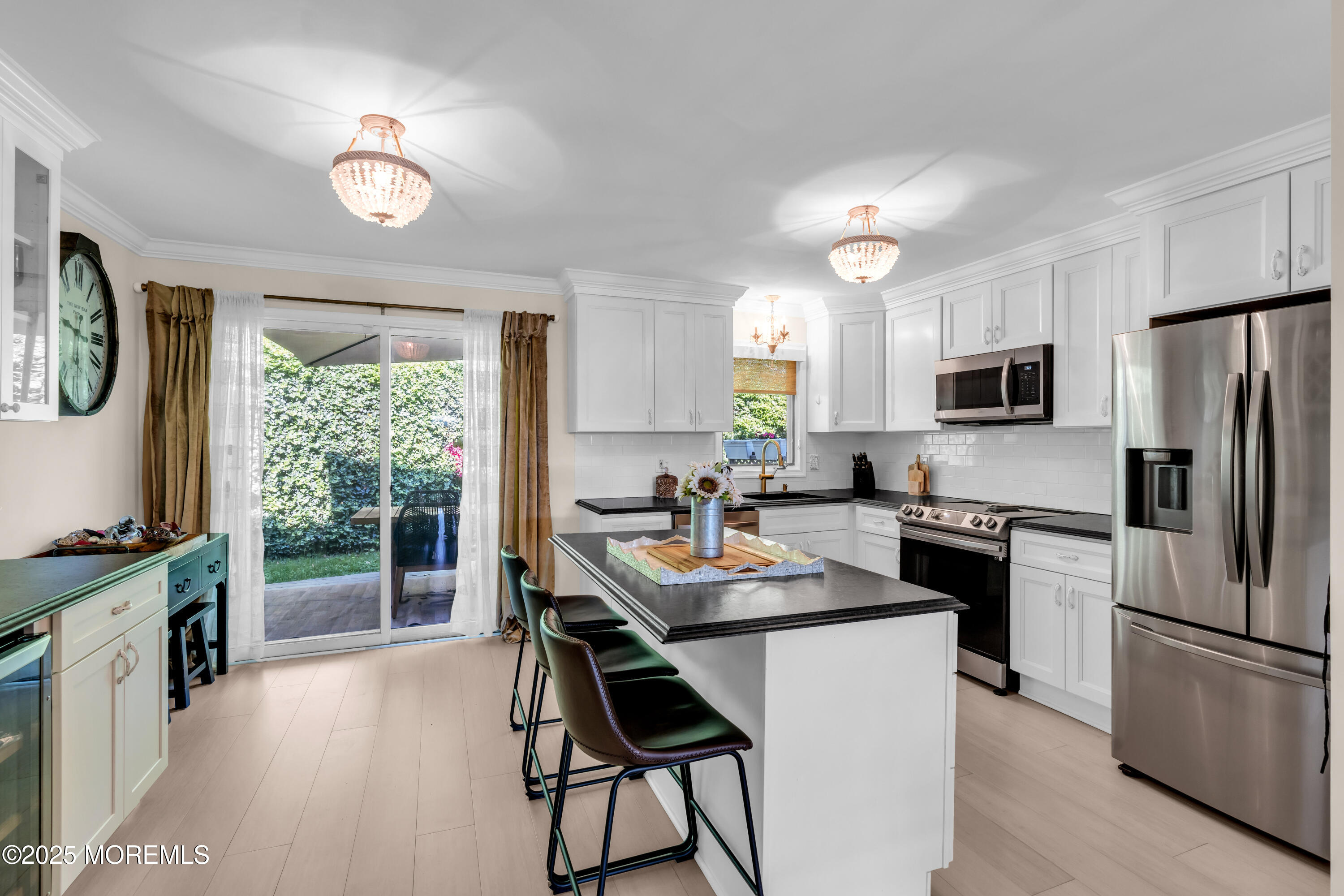 1 Portland Road, Unit 13 Highlands, NJ 07732 - Photo 13 of 40 a kitchen with a table chairs refrigerator and microwave