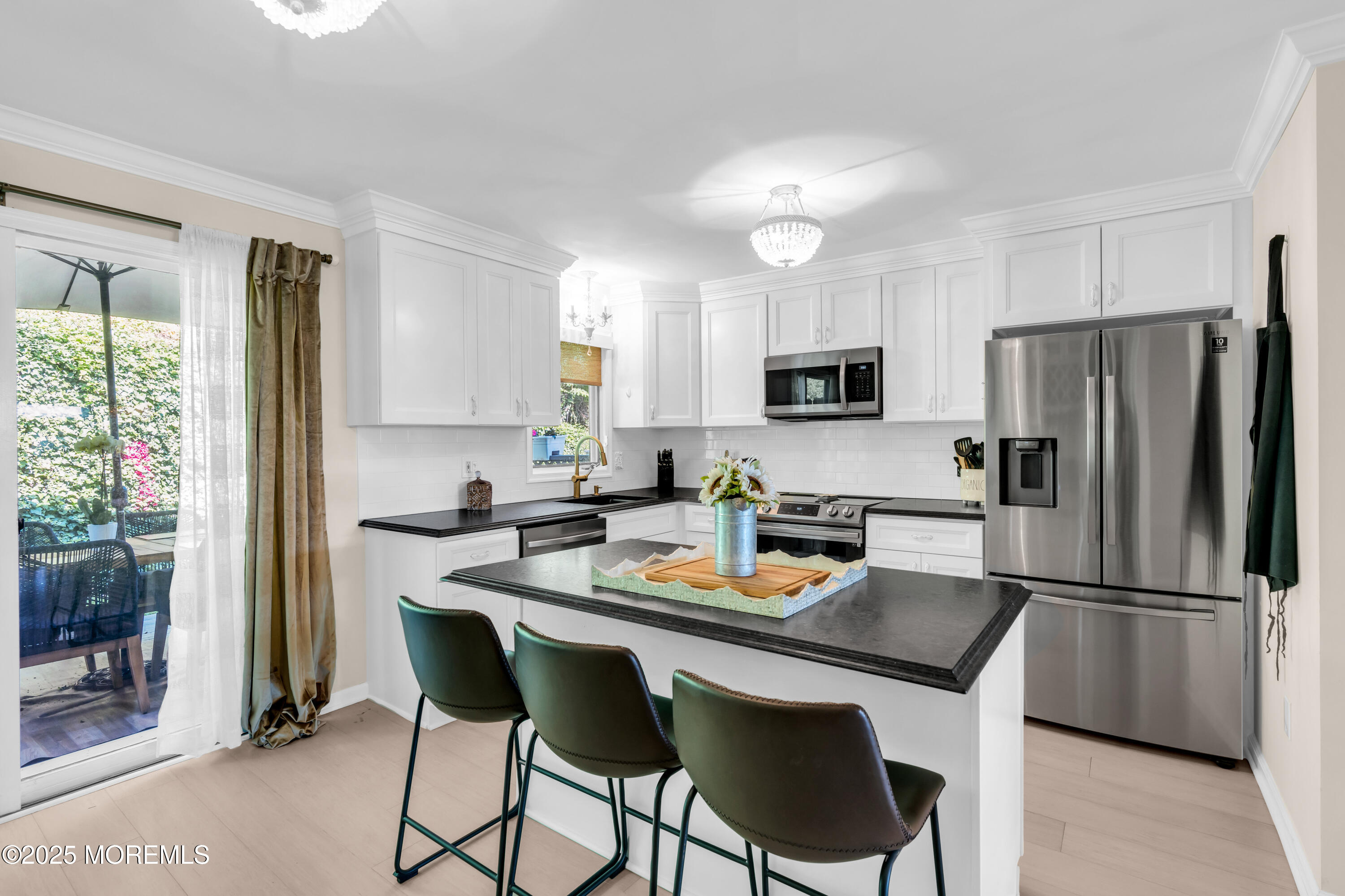 1 Portland Road, Unit 13 Highlands, NJ 07732 - Photo 14 of 40 a kitchen with stainless steel appliances granite countertop a refrigerator a stove a microwave a sink and white cabinets with wooden floor