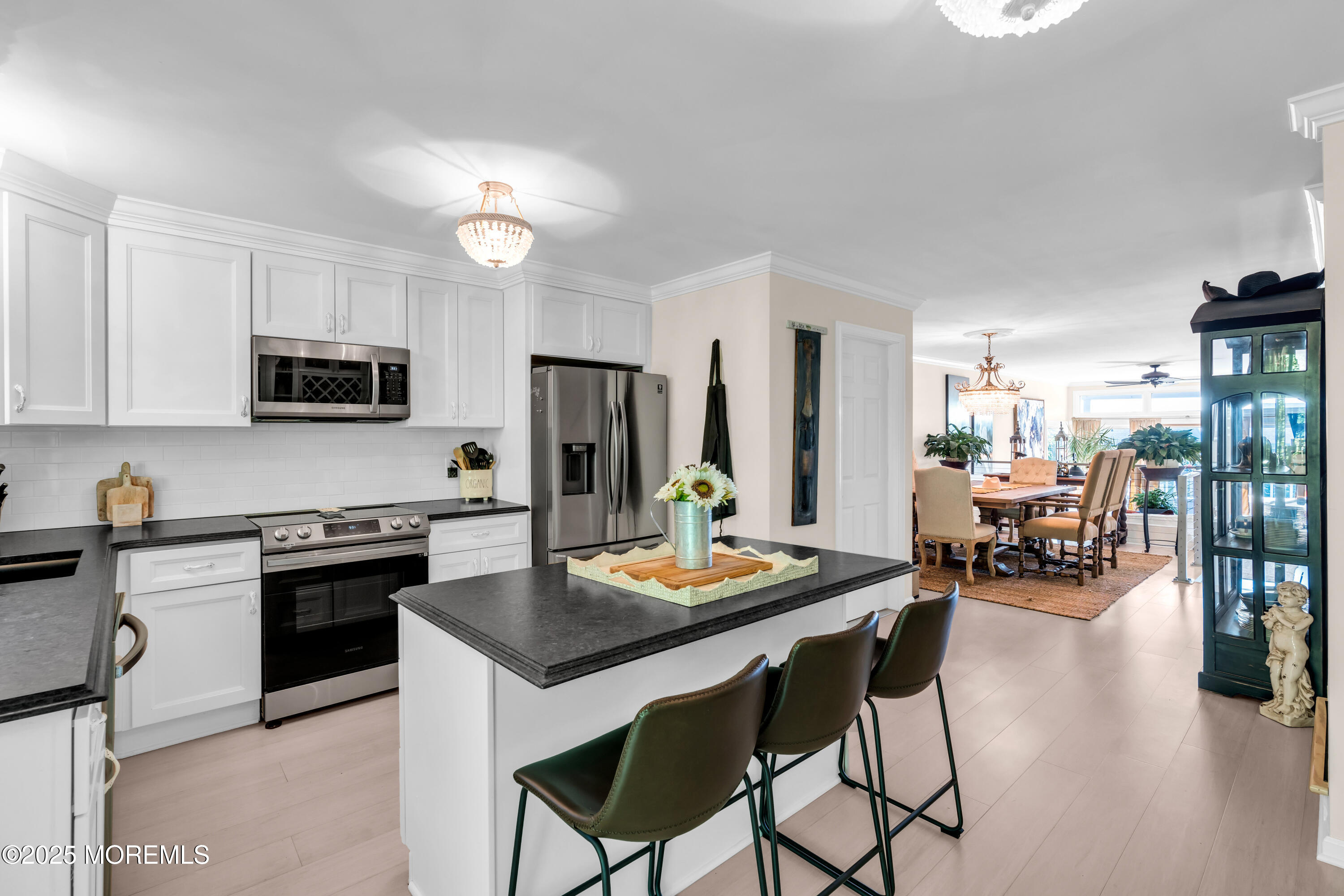 1 Portland Road, Unit 13 Highlands, NJ 07732 - Photo 15 of 40 a kitchen with stainless steel appliances kitchen island granite countertop a table chairs and a refrigerator
