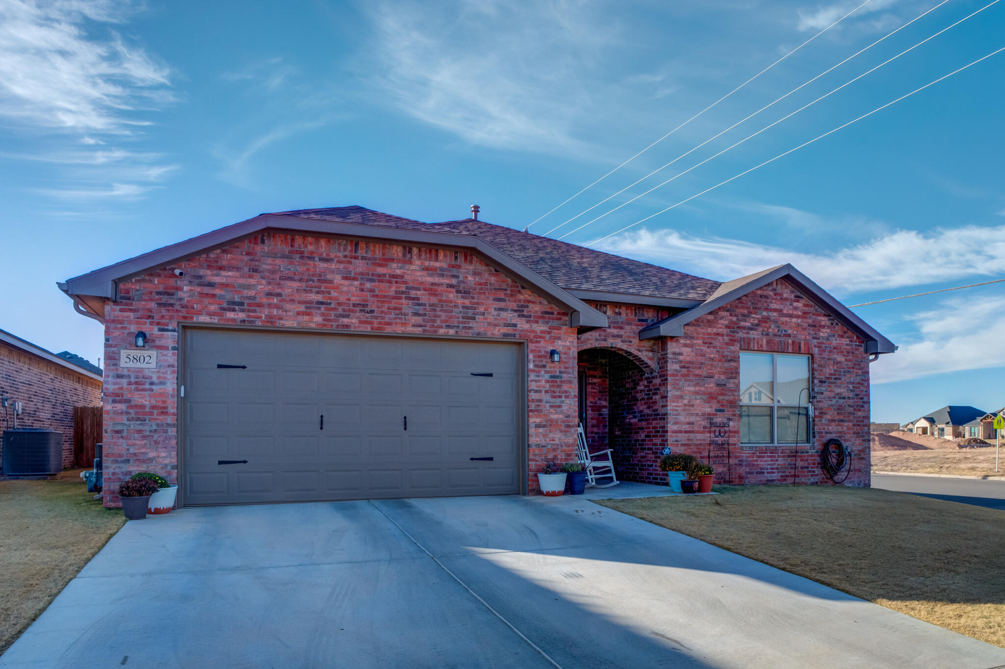 5802 Winfield Avenue Lubbock, TX 79407 - Photo 1 of 36 a front view of a house with a yard