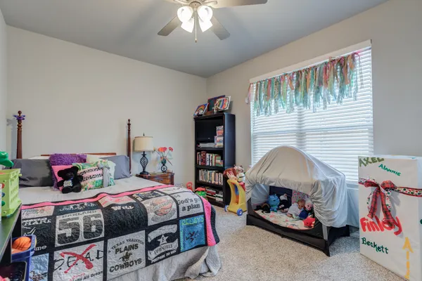 a bedroom with bed and a chandelier