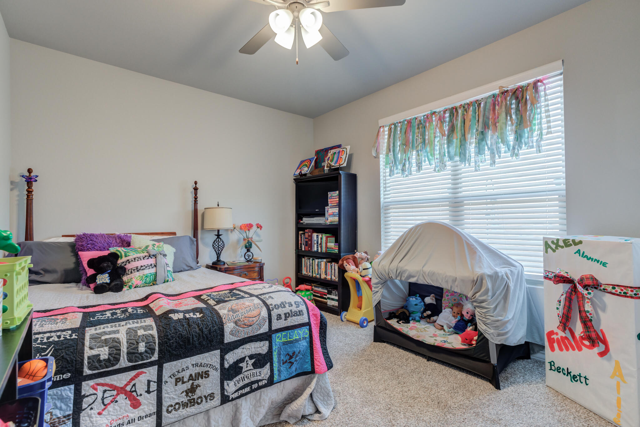 5802 Winfield Avenue Lubbock, TX 79407 - Photo 18 of 36 a bedroom with bed and a chandelier