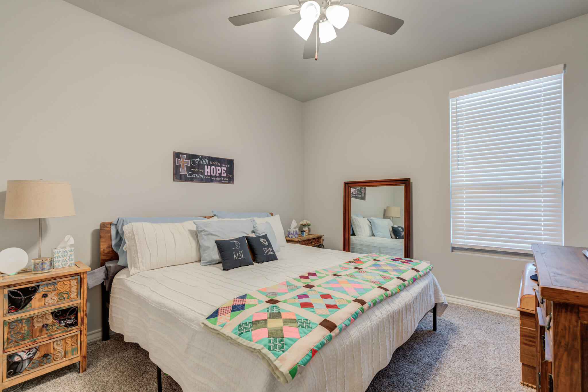 5802 Winfield Avenue Lubbock, TX 79407 - Photo 22 of 36 a bedroom with a bed and a chandelier