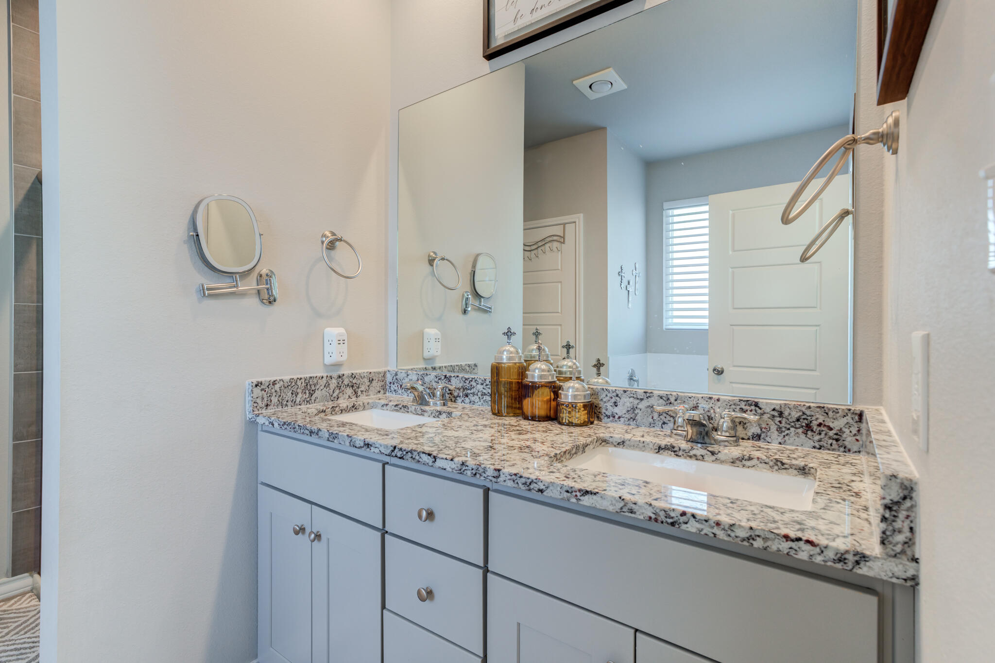 5802 Winfield Avenue Lubbock, TX 79407 - Photo 27 of 36 a bathroom with a granite countertop sink and a mirror