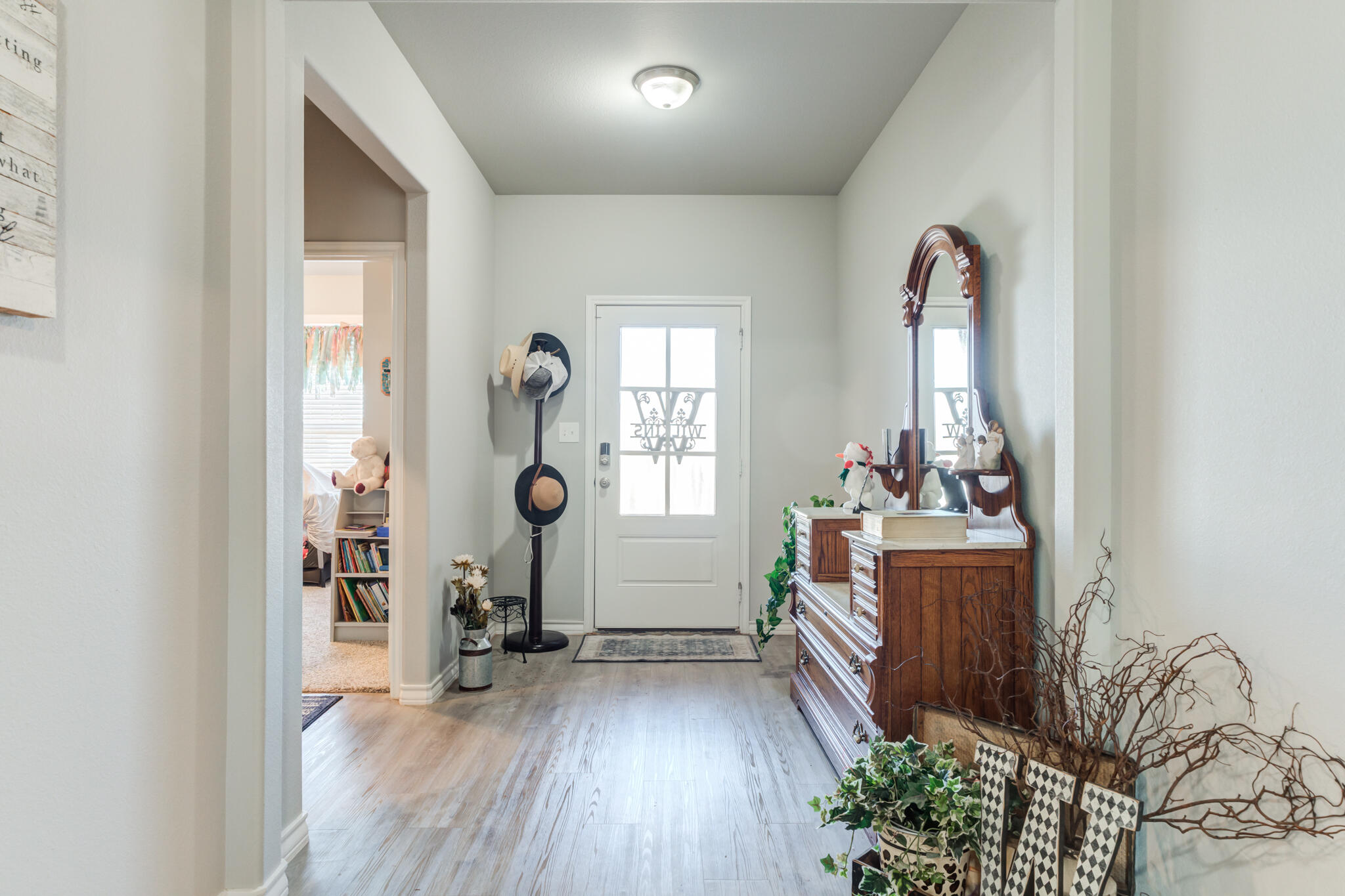 5802 Winfield Avenue Lubbock, TX 79407 - Photo 5 of 36 a room that has a lot of furniture and wooden floor