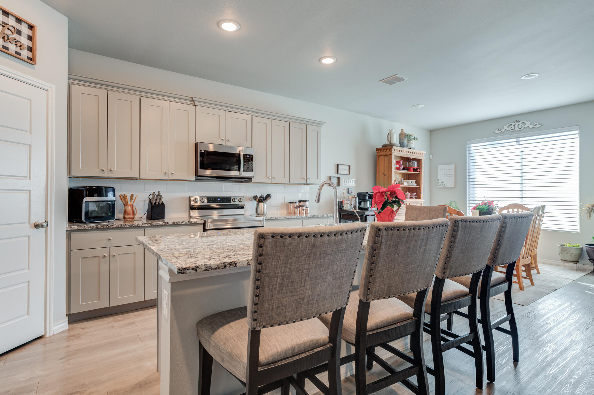 5802 Winfield Avenue Lubbock, TX 79407 - Photo 9 of 36 a kitchen with a dining table chairs and microwave
