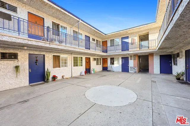 a front view of a house with glass door and furniture
