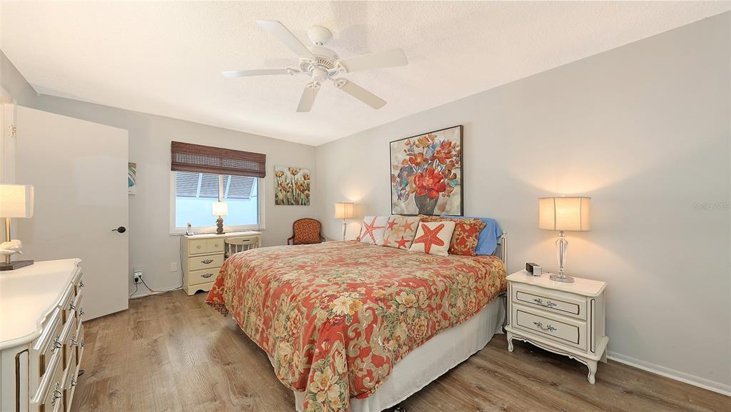 5641 Midnight Pass Road, Unit 904 Sarasota, FL 34242 - Photo 11 of 24 a bedroom with a bed and a dresser