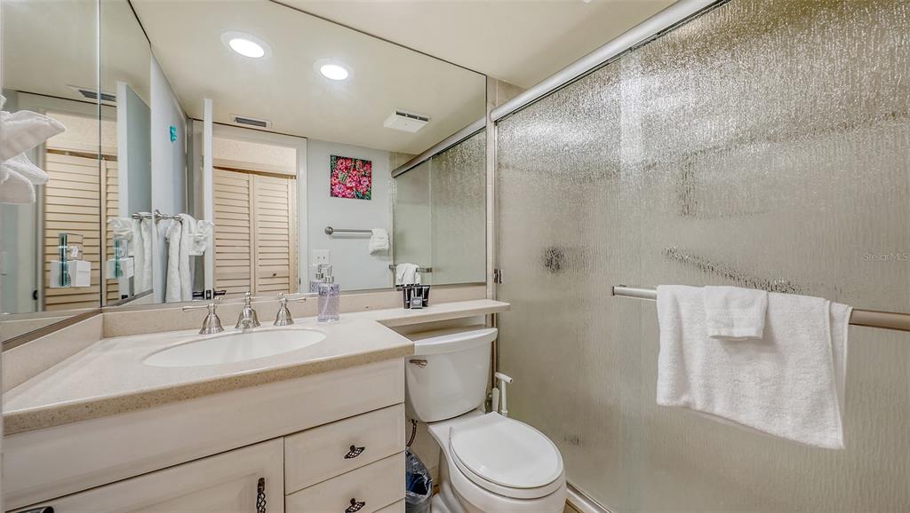 5641 Midnight Pass Road, Unit 904 Sarasota, FL 34242 - Photo 13 of 24 a bathroom with a sink toilet vanity and shower