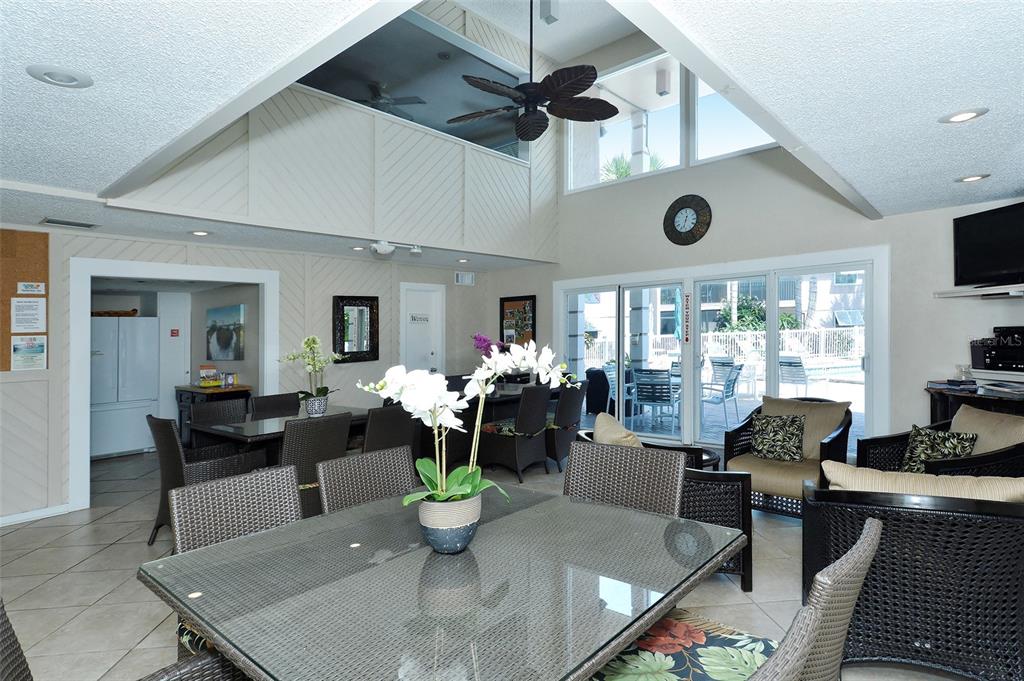 5641 Midnight Pass Road, Unit 904 Sarasota, FL 34242 - Photo 15 of 24 a living room with furniture a chandelier and a dining table