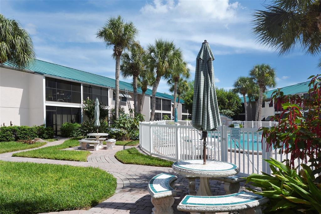 5641 Midnight Pass Road, Unit 904 Sarasota, FL 34242 - Photo 18 of 24 a view of a house with backyard and sitting area