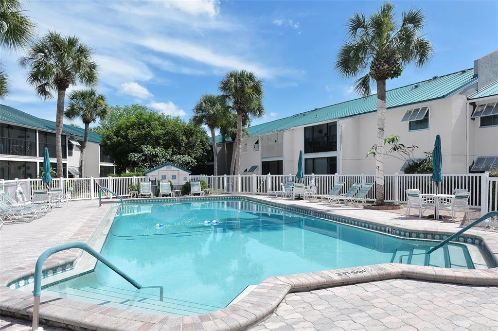 5641 Midnight Pass Road, Unit 904 Sarasota, FL 34242 - Photo 19 of 24 a view of a swimming pool with a patio