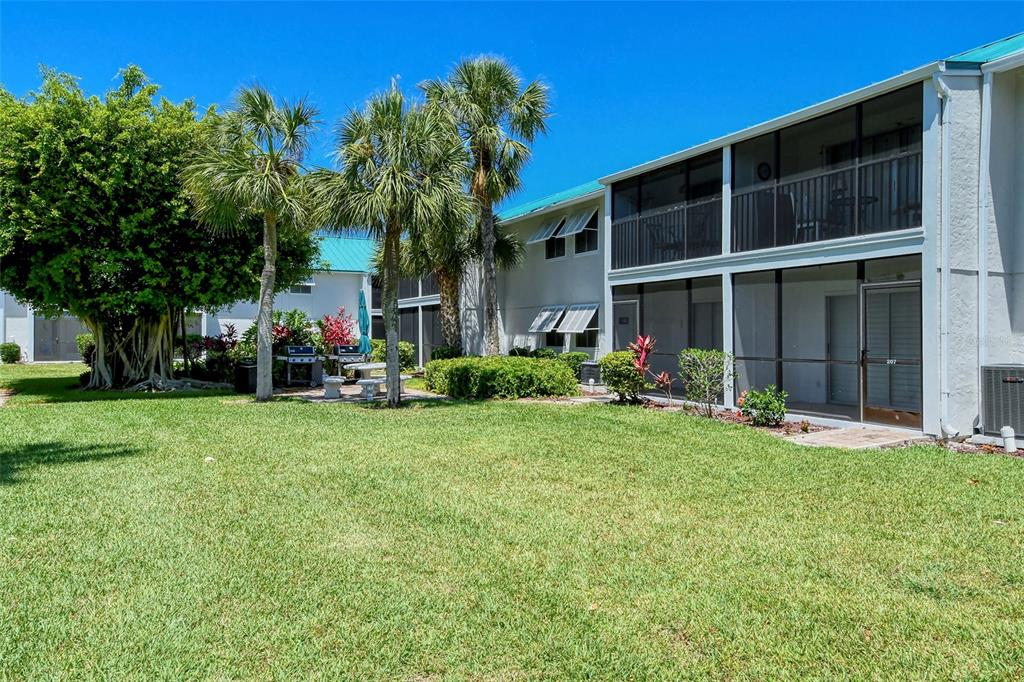 5641 Midnight Pass Road, Unit 904 Sarasota, FL 34242 - Photo 21 of 24 a view of a house with a yard porch and sitting area