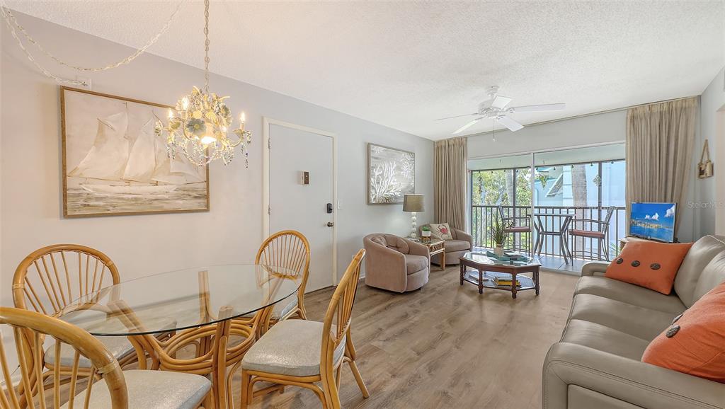 5641 Midnight Pass Road, Unit 904 Sarasota, FL 34242 - Photo 4 of 24 a living room with furniture chess table and a large window