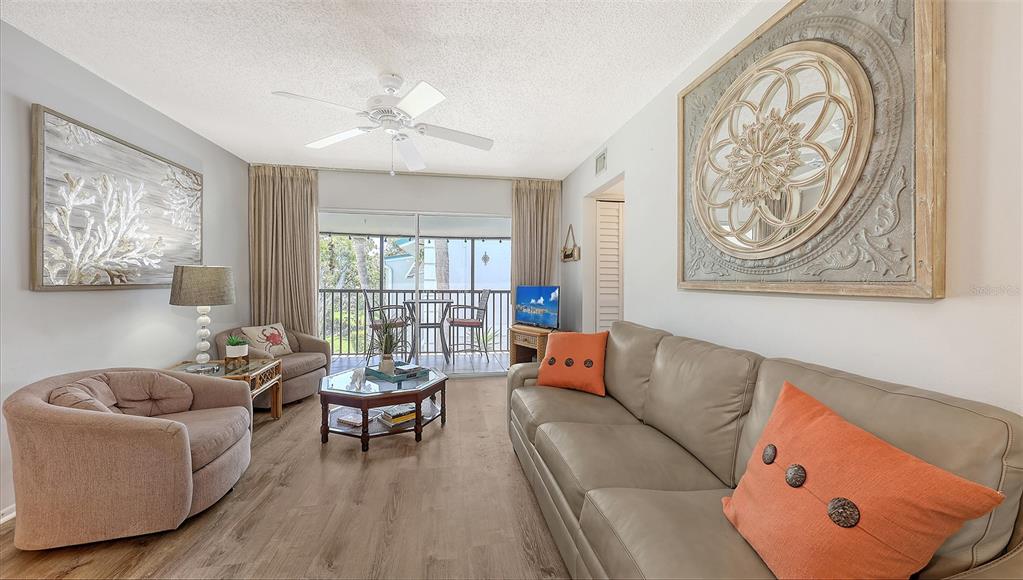 5641 Midnight Pass Road, Unit 904 Sarasota, FL 34242 - Photo 5 of 24 a living room with furniture and window
