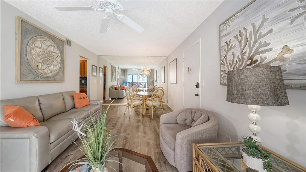 5641 Midnight Pass Road, Unit 904 Sarasota, FL 34242 - Photo 8 of 24 a living room with furniture and a chandelier