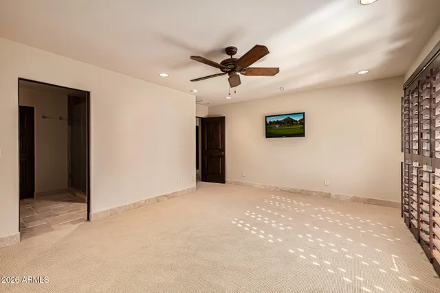 a view of a street with a building and couple of cars parked in front of it