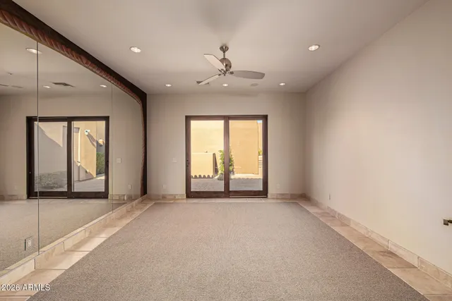 a view of a balcony with wooden floor and fence