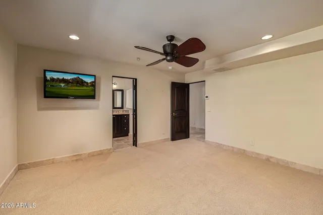 a view of a patio with dining table and chairs under an umbrella
