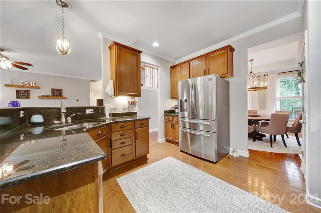 823 Solandra Way Tega Cay, SC 29708 - Photo 14 of 43 a kitchen with stainless steel appliances granite countertop a refrigerator stove and sink