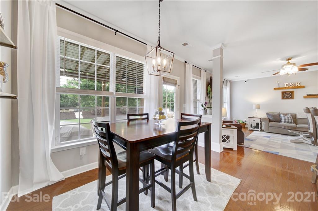 823 Solandra Way Tega Cay, SC 29708 - Photo 15 of 43 a view of a dining room with furniture window and wooden floor