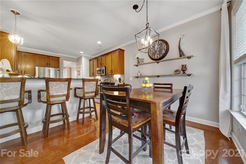 823 Solandra Way Tega Cay, SC 29708 - Photo 16 of 43 a view of a dining room with furniture and a chandelier