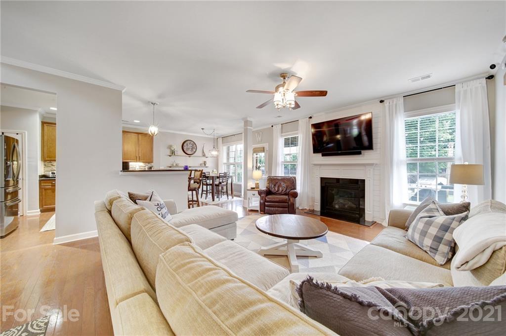 823 Solandra Way Tega Cay, SC 29708 - Photo 19 of 43 a living room with furniture a fireplace and a flat screen tv