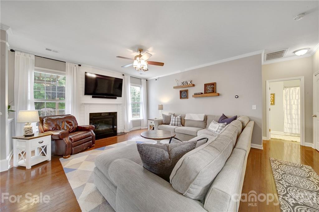 823 Solandra Way Tega Cay, SC 29708 - Photo 20 of 43 a living room with furniture a fireplace and a flat screen tv