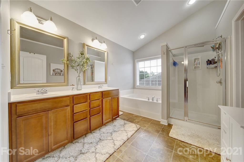 823 Solandra Way Tega Cay, SC 29708 - Photo 32 of 43 a spacious bathroom with a tub sink shower and mirror