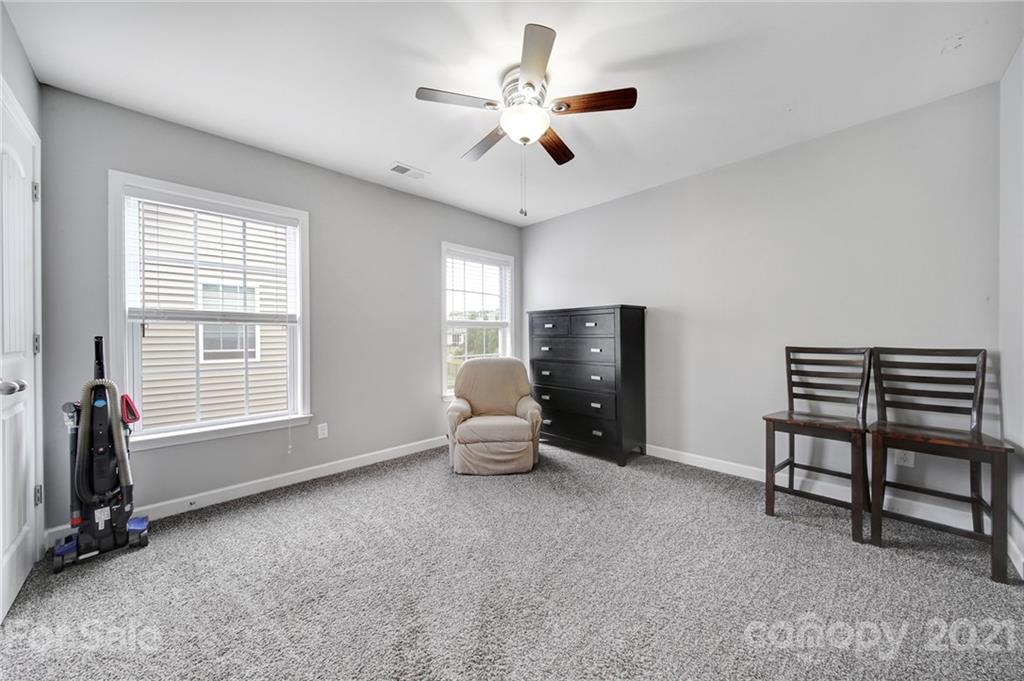 823 Solandra Way Tega Cay, SC 29708 - Photo 33 of 43 a living room with furniture a ceiling fan and a window