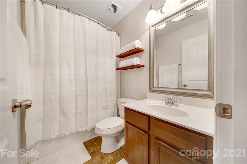 823 Solandra Way Tega Cay, SC 29708 - Photo 35 of 43 a bathroom with a sink a toilet and shower