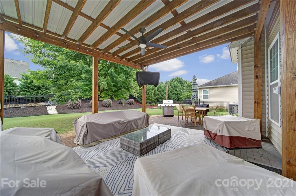 823 Solandra Way Tega Cay, SC 29708 - Photo 38 of 43 a living room with patio furniture and a garden
