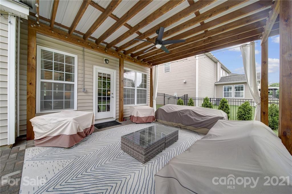 823 Solandra Way Tega Cay, SC 29708 - Photo 39 of 43 a balcony with furniture and a potted plant
