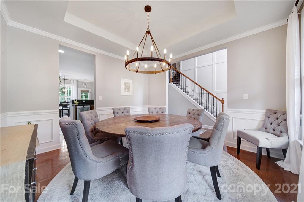 823 Solandra Way Tega Cay, SC 29708 - Photo 9 of 43 a view of a dining room with furniture window and wooden floor