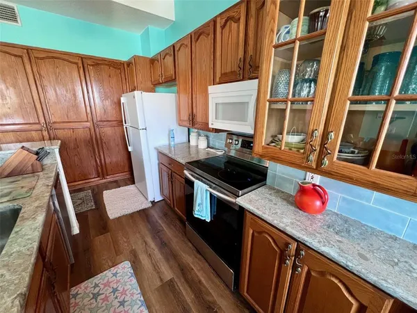 a view of a balcony with wooden floor and city view